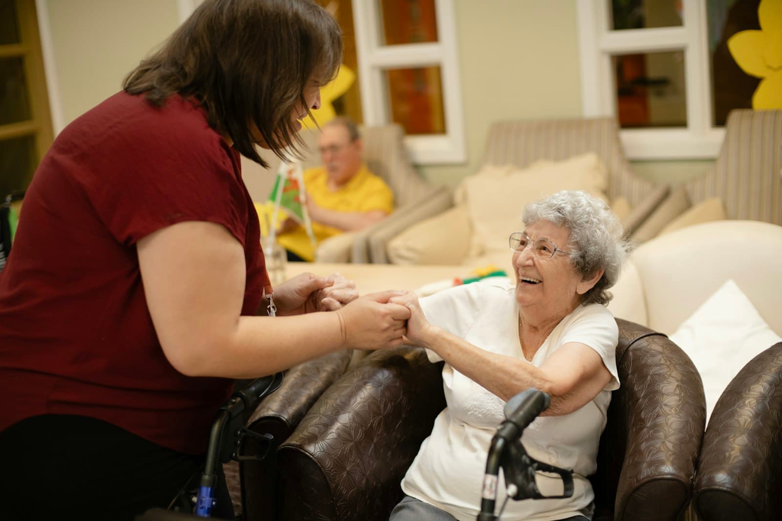 A caregiver helping an elderly man at home