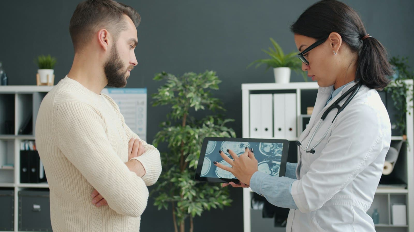 A doctor reviewing a patient's plan on a tablet