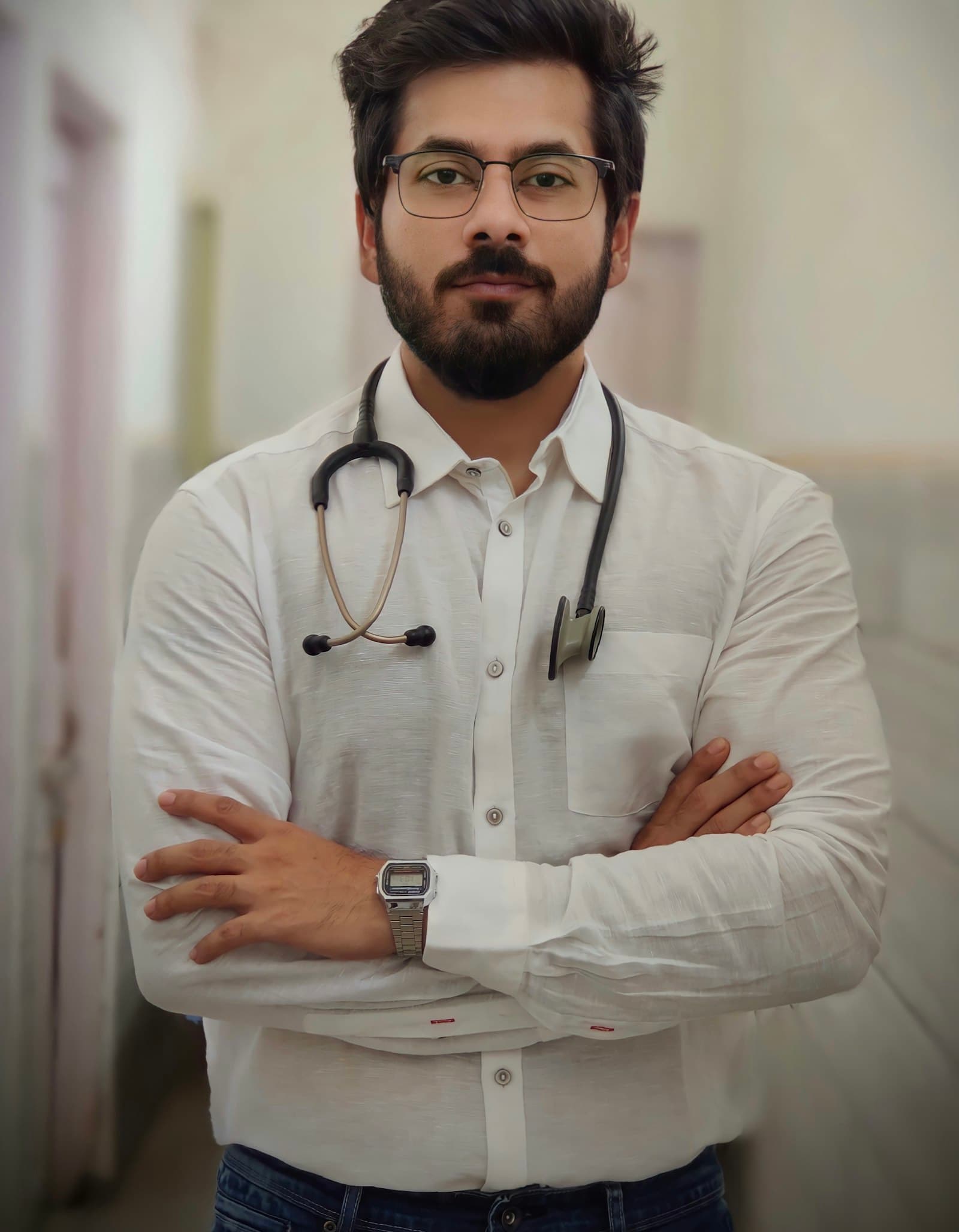 A smiling doctor standing in a corridor