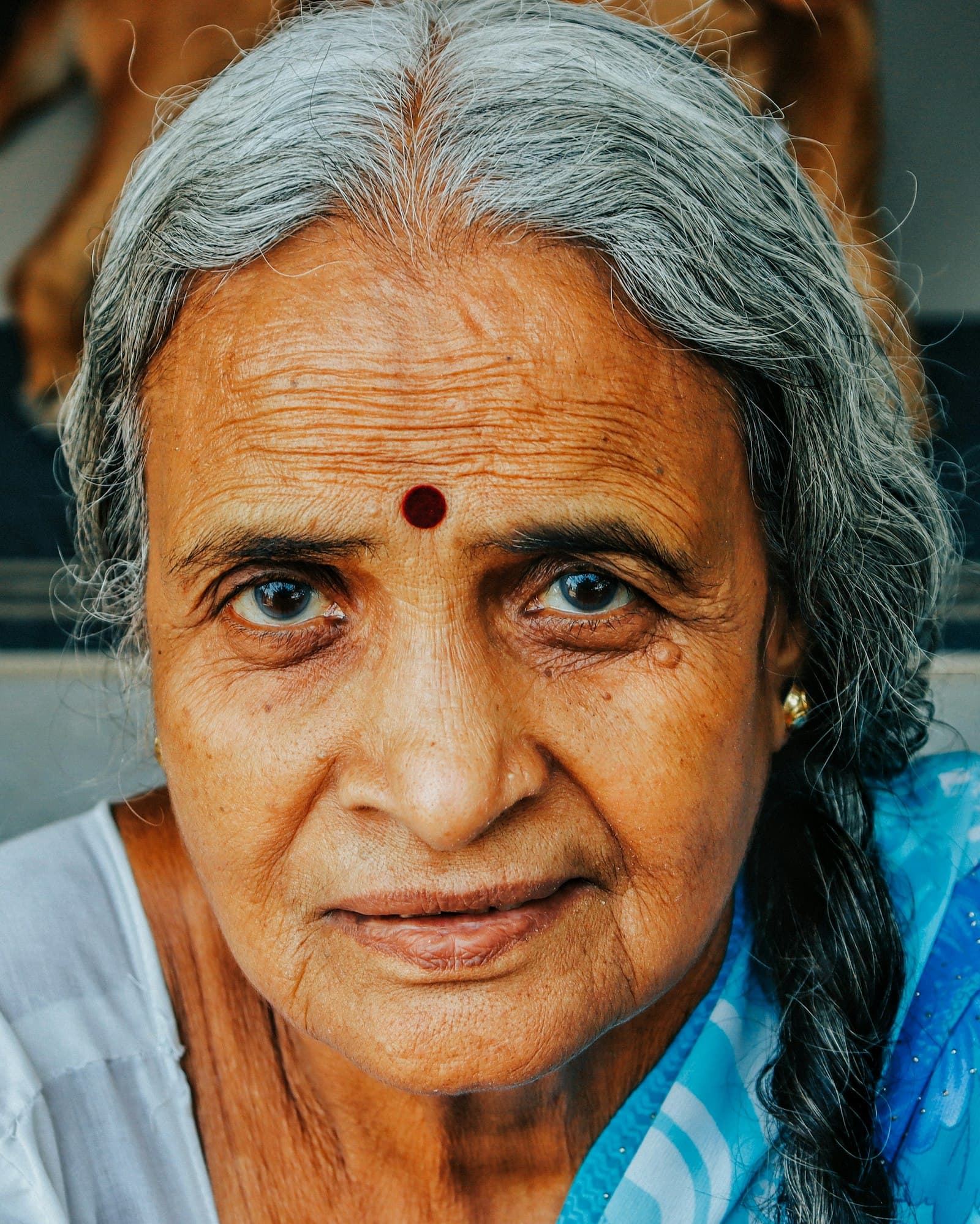 An elderly woman smiling with her family