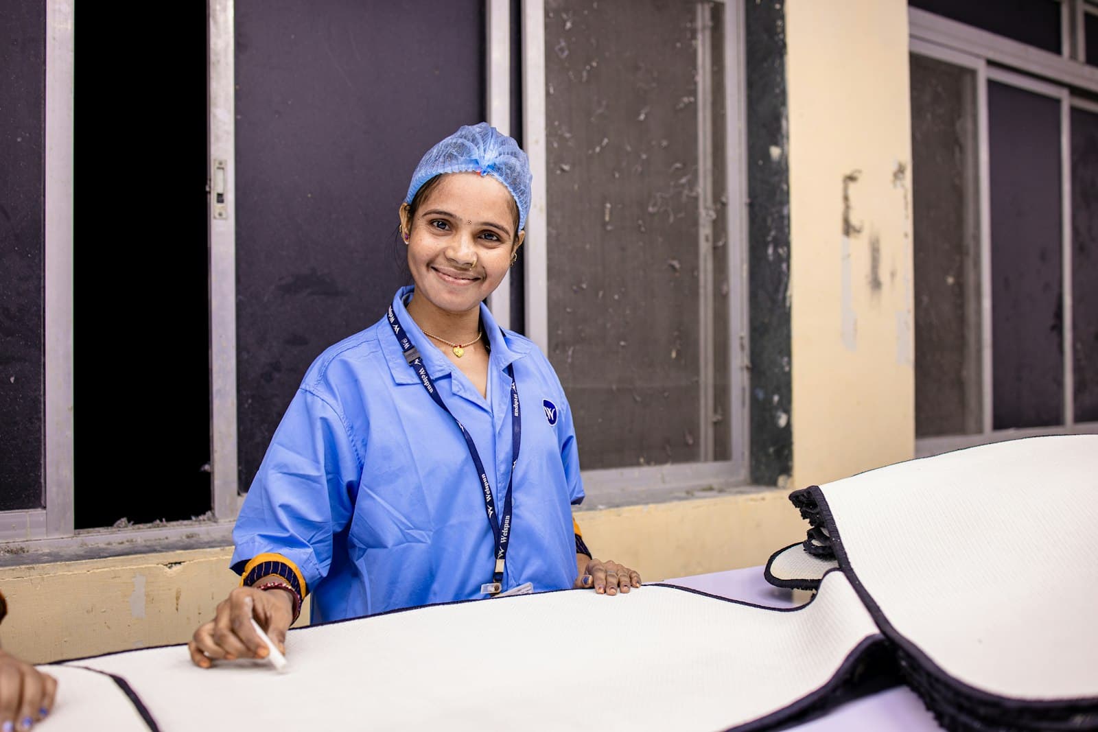 A female nurse in scrubs smiling at the camera